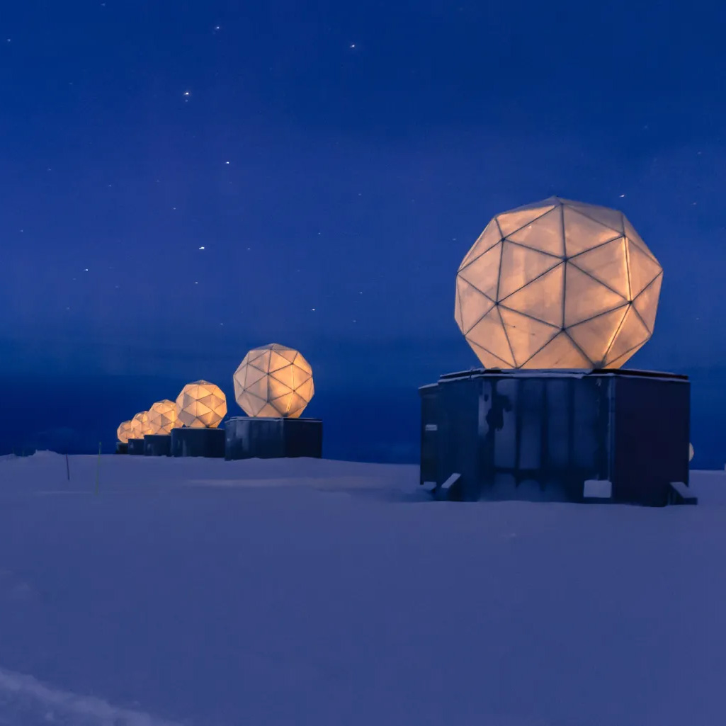 Satellite communication station with radar domes in Antarctica demonstrating connectivity in remote polar regions.